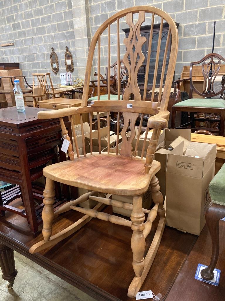 A reproduction beech Windsor rocking chair, width 63cm, depth 52cm, height 110cm